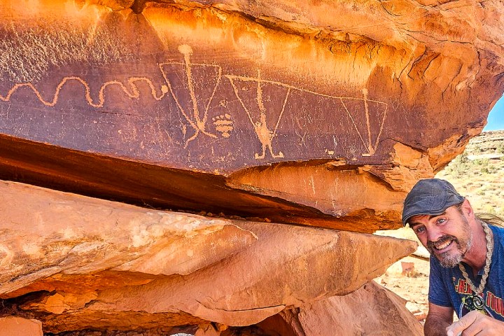 Guide Sean-Paul showing off petroglyph on the Hurrah Pass Tour